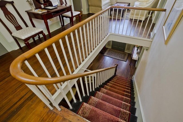 stairs featuring wood finished floors