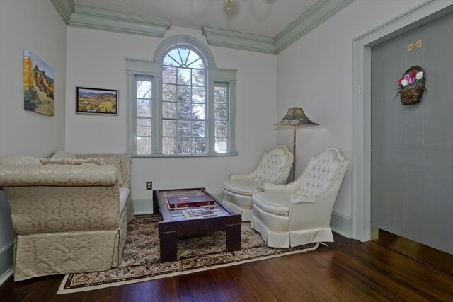 sitting room with wood finished floors and ornamental molding