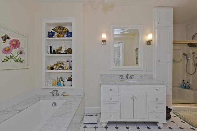 full bathroom with vanity, a shower stall, built in shelves, and a garden tub
