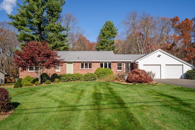 single story home with a garage and a front yard