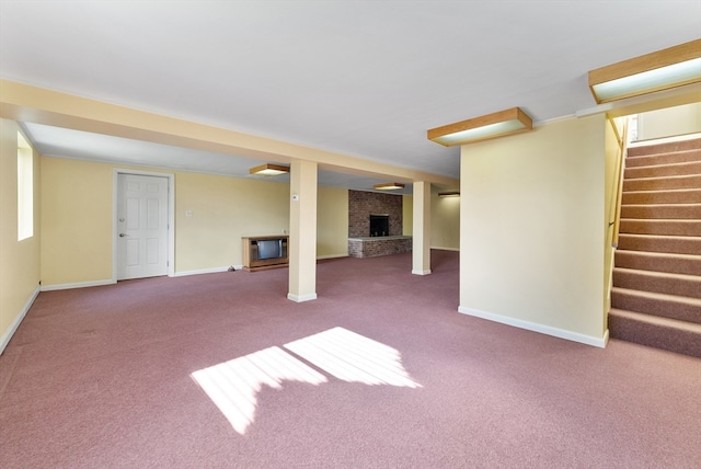 basement featuring a fireplace and carpet