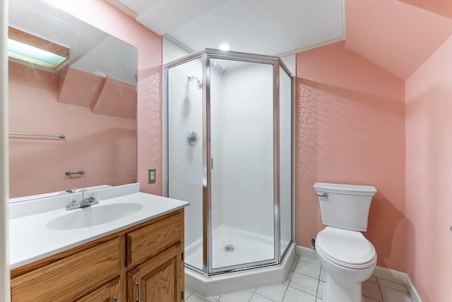 bathroom featuring toilet, vanity, tile patterned floors, and a shower with door