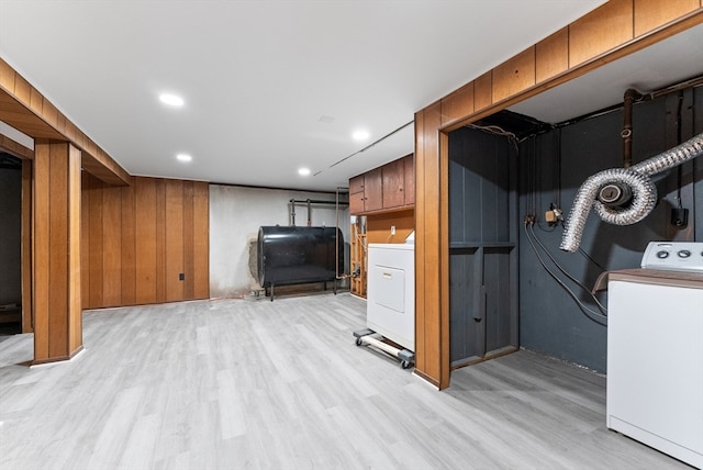 basement with light hardwood / wood-style flooring and washer / dryer