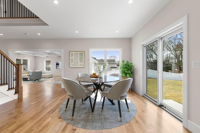 dining space featuring recessed lighting, light wood-type flooring, stairs, and baseboards