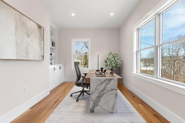 office featuring recessed lighting, baseboards, and light wood-style floors