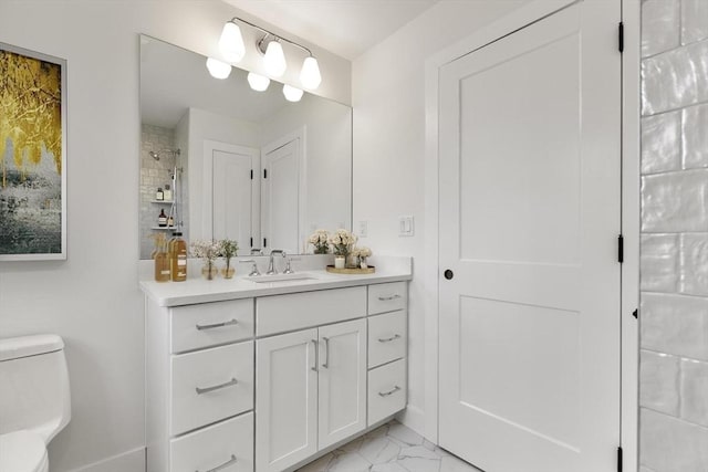 full bathroom with toilet, marble finish floor, vanity, and a tile shower