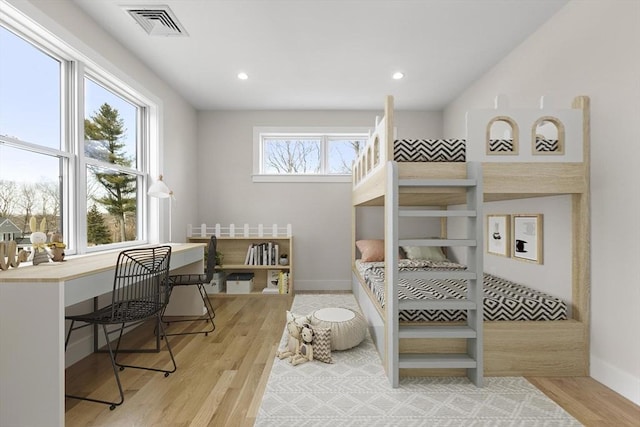 bedroom featuring visible vents, recessed lighting, light wood-type flooring, and baseboards