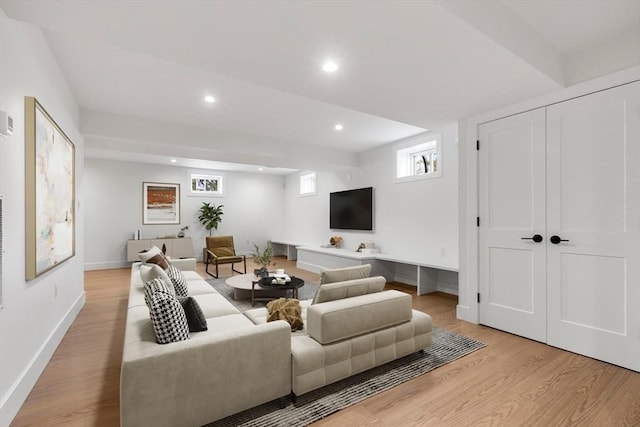 living area with light wood-style flooring, recessed lighting, and baseboards