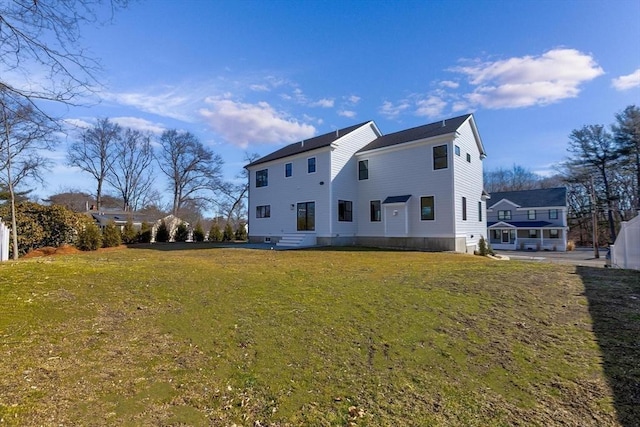 back of property featuring a lawn