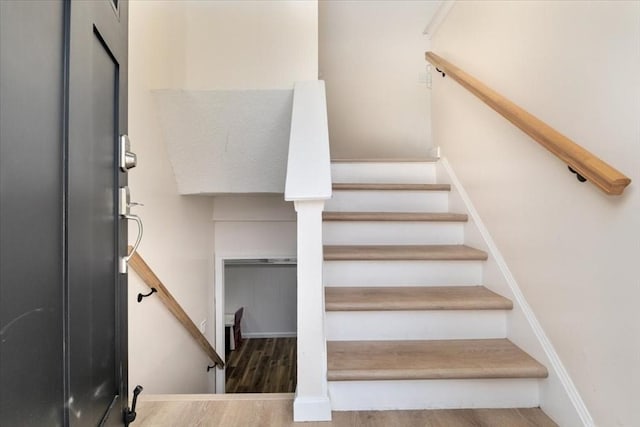 stairway with hardwood / wood-style flooring