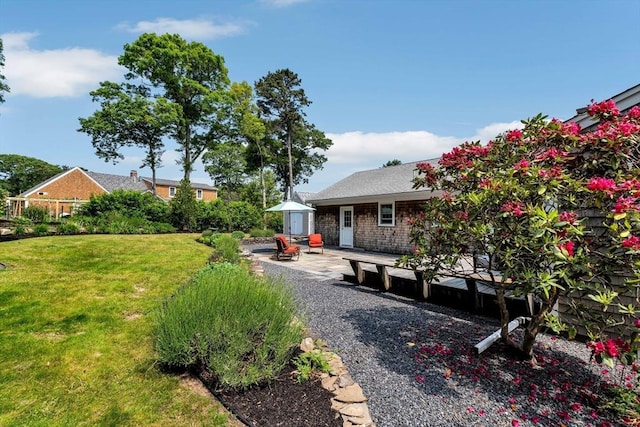 25 Pheasant Cove Cir, Yarmouth, MA 02675 - view of green lawn featuring a patio area
