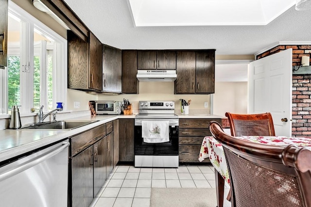 25 Pheasant Cove Cir, Yarmouth, MA 02675 - kitchen featuring appliances with stainless steel finishes, under cabinet range hood, light countertops, light tile patterned floors, and dark brown cabinets