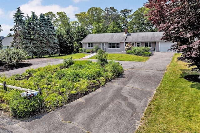 25 Pheasant Cove Cir, Yarmouth, MA 02675 - single story home featuring driveway, a garage, a front yard, and a chimney