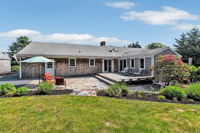 25 Pheasant Cove Cir, Yarmouth, MA 02675 - back of property featuring a lawn, a wooden deck, a chimney, and a patio