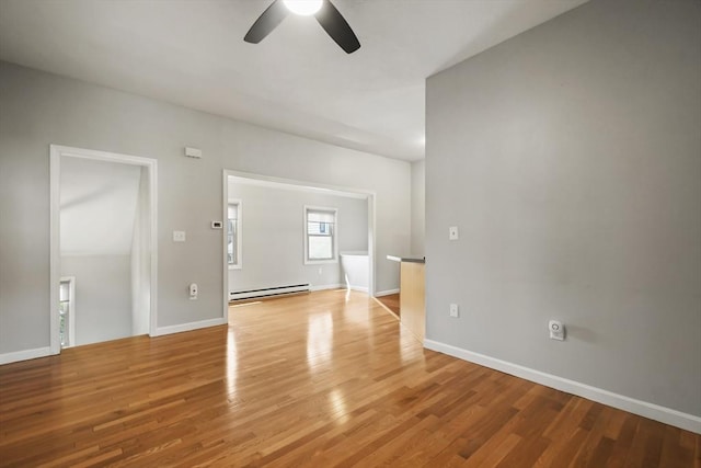 192 Pleasant St Unit 3, Leominster, MA 01453 - spare room with a baseboard heating unit, a ceiling fan, light wood-type flooring, and baseboards