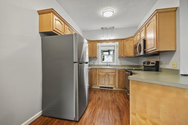 192 Pleasant St Unit 3, Leominster, MA 01453 - kitchen featuring appliances with stainless steel finishes, a sink, dark wood-style flooring, and light countertops