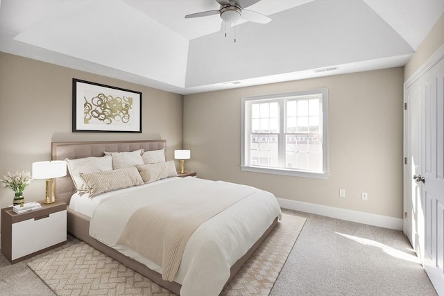 bedroom with a ceiling fan, baseboards, visible vents, vaulted ceiling, and light colored carpet