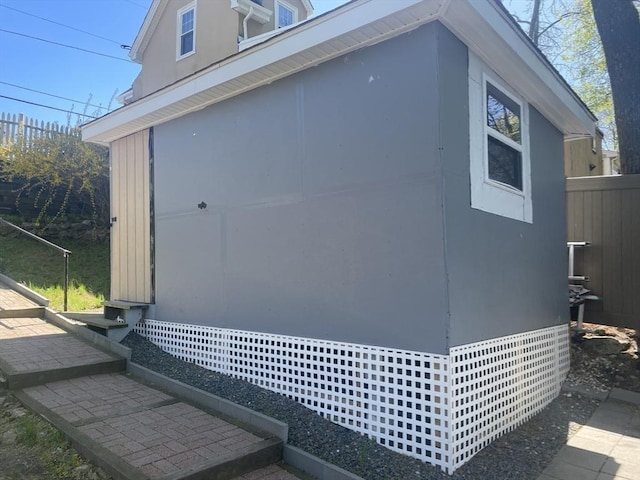view of outbuilding with fence