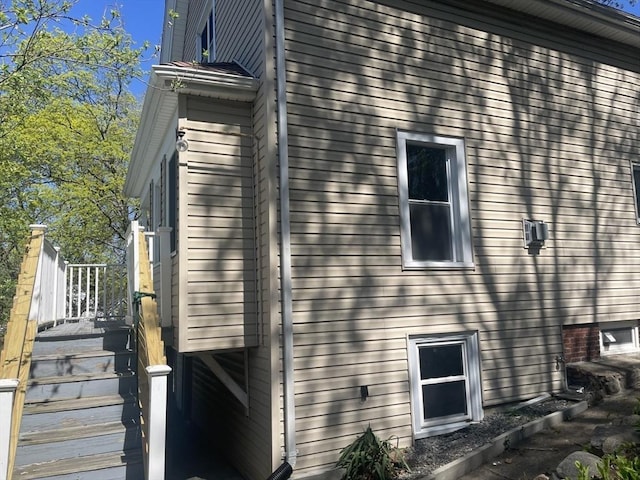 view of side of property featuring stairway