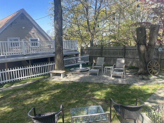 view of yard with a deck and fence