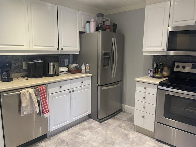 kitchen featuring light countertops, appliances with stainless steel finishes, tasteful backsplash, and white cabinetry