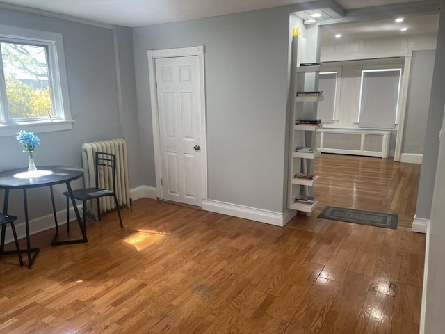 interior space featuring wood finished floors, baseboards, and radiator heating unit