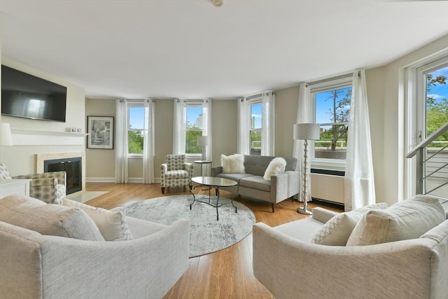 47 Harvard St Unit B402, Boston, MA 02129 - living room with plenty of natural light, a fireplace with flush hearth, wood finished floors, and baseboards