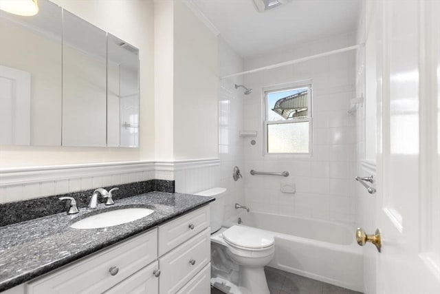 full bathroom featuring tiled shower / bath combo, vanity, tile patterned floors, and toilet