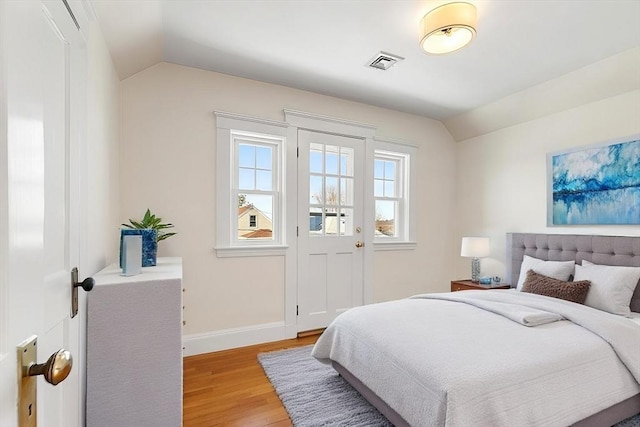 bedroom featuring vaulted ceiling and light hardwood / wood-style floors