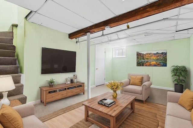 living room with light hardwood / wood-style floors and beamed ceiling