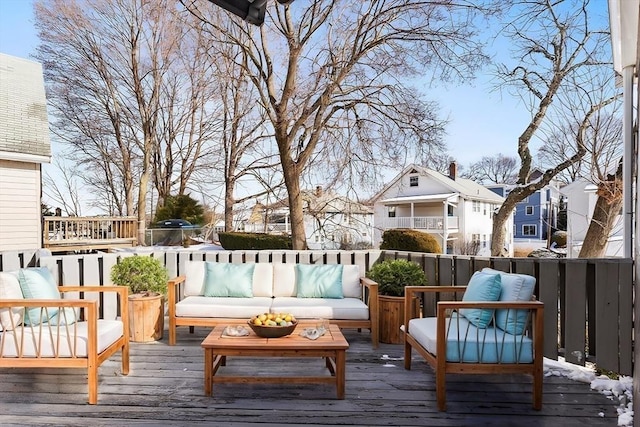 wooden terrace with an outdoor living space