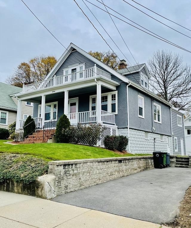 view of front of house featuring a front yard and covered porch