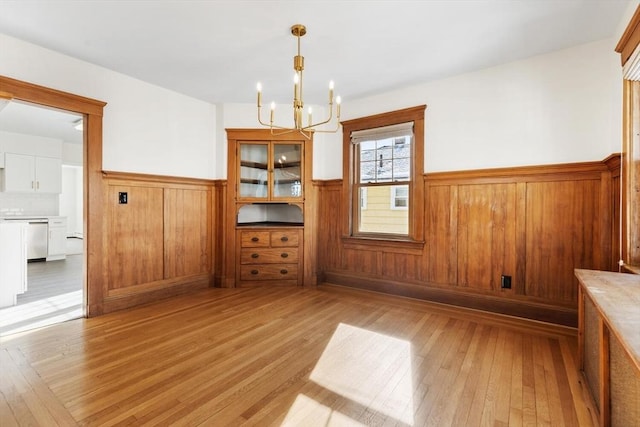 interior space with an inviting chandelier and light wood-type flooring