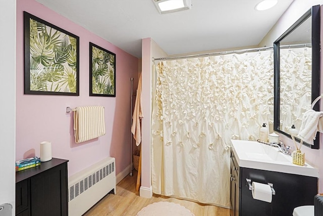 22 Tampa St, Worcester, MA 01604 - full bath with radiator heating unit, wood finished floors, toilet, vanity, and curtained shower