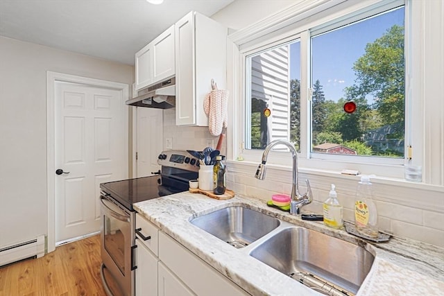 22 Tampa St, Worcester, MA 01604 - kitchen featuring stainless steel electric stove, a sink, a baseboard heating unit, under cabinet range hood, and decorative backsplash