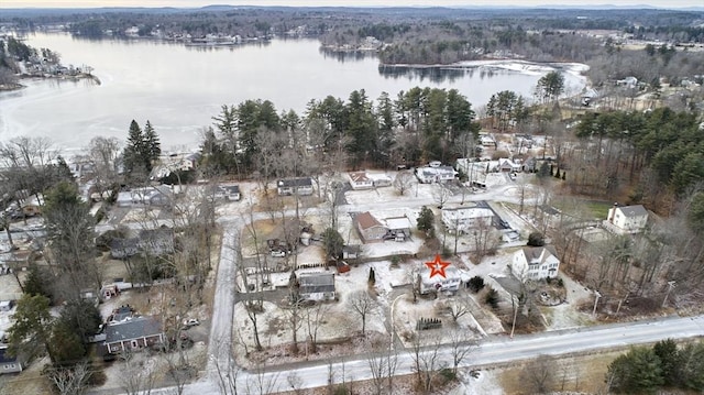 snowy aerial view with a water view