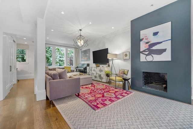 9 Bond St, Boston, MA 02118 - living area with a fireplace, wood finished floors, recessed lighting, and a chandelier