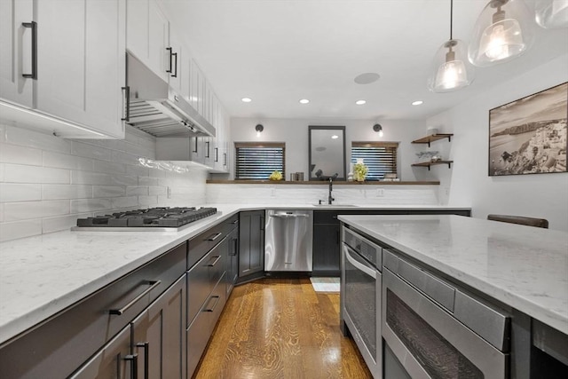 9 Bond St, Boston, MA 02118 - kitchen featuring appliances with stainless steel finishes, under cabinet range hood, wood finished floors, recessed lighting, and tasteful backsplash