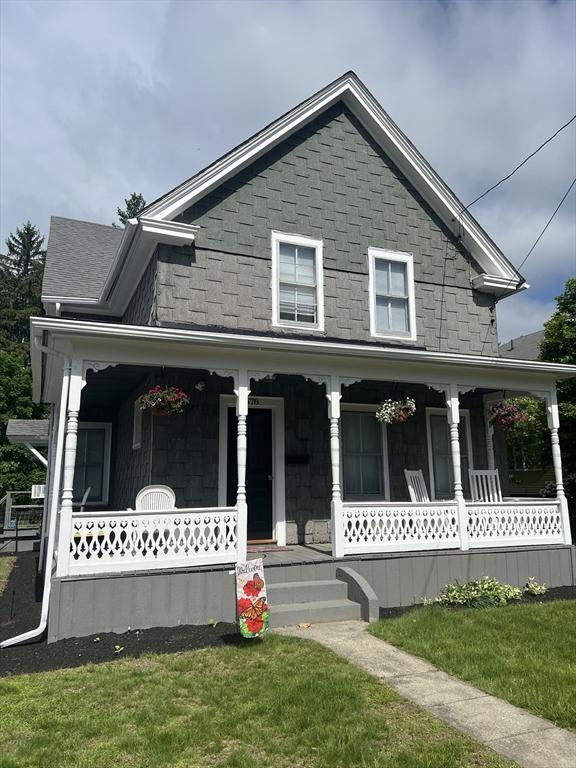 678 School St, Webster, MA 01570 - victorian house featuring a porch, a front lawn, and stone siding
