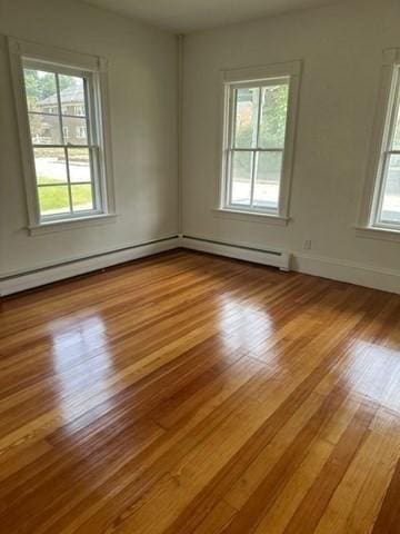 678 School St, Webster, MA 01570 - empty room with wood finished floors and baseboard heating
