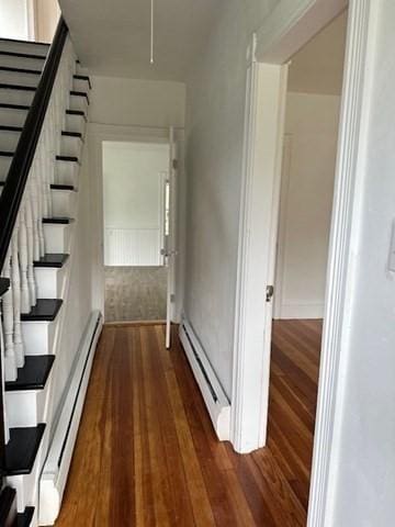 678 School St, Webster, MA 01570 - hall with dark wood finished floors, a baseboard heating unit, and stairway