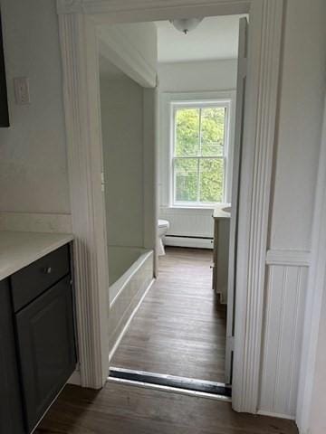 678 School St, Webster, MA 01570 - full bath with vanity, toilet, wood finished floors, and baseboard heating