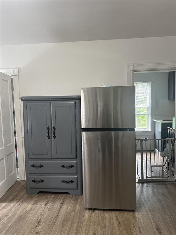 678 School St, Webster, MA 01570 - kitchen featuring freestanding refrigerator, wood finished floors, and gray cabinetry