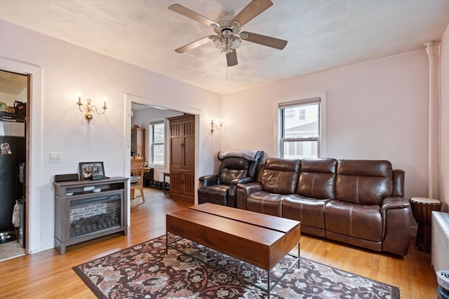 living room featuring light hardwood / wood-style floors and ceiling fan