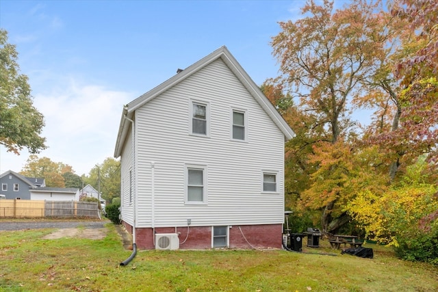 back of house with a lawn and ac unit