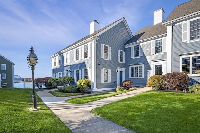 view of front of house featuring a front yard and a chimney