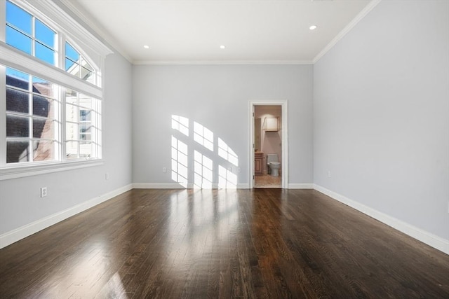 empty room with ornamental molding and dark hardwood / wood-style floors