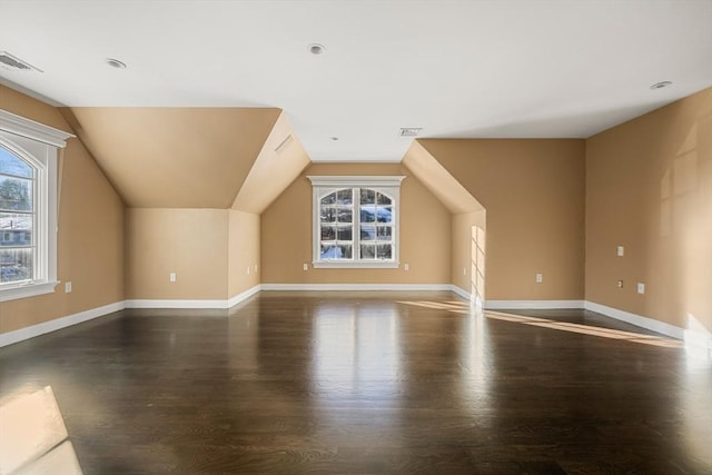 bonus room featuring lofted ceiling and dark hardwood / wood-style floors