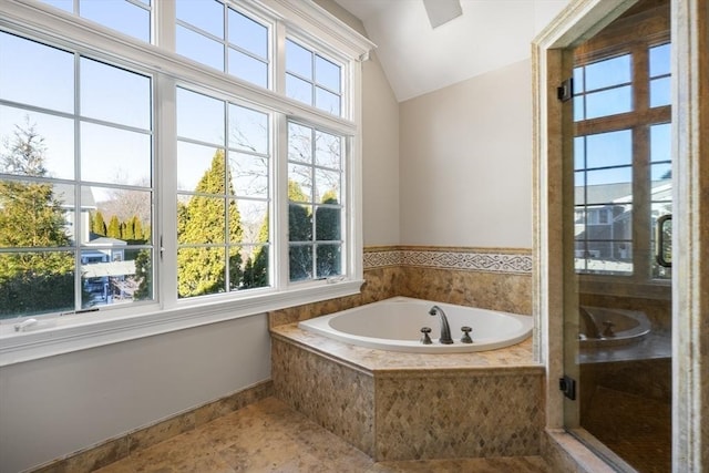 bathroom with lofted ceiling and shower with separate bathtub