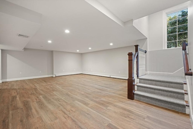 basement with light hardwood / wood-style floors